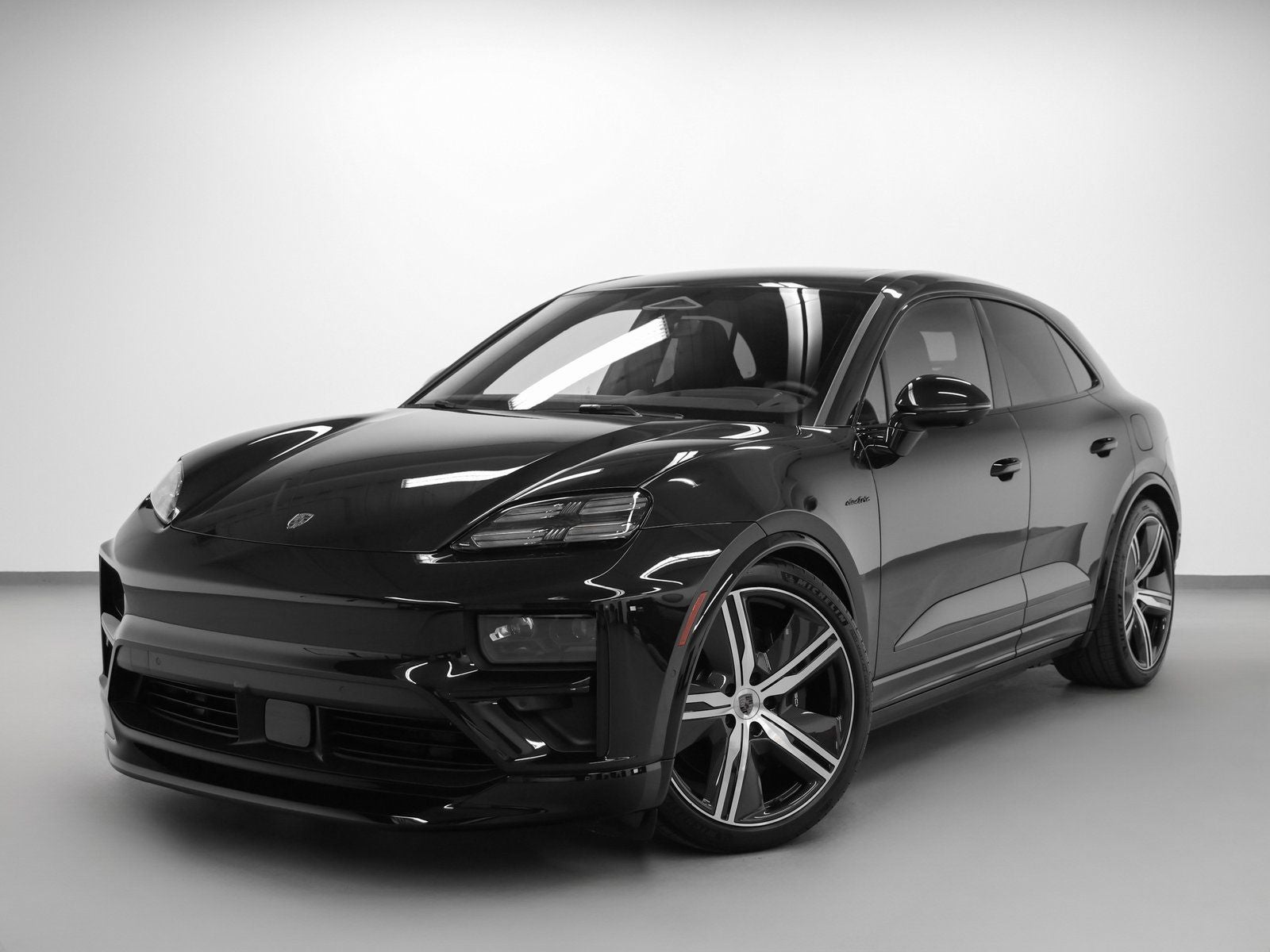 2025 Porsche Macan Macan Turbo Electric in Jet Black Metallic — front three-quarter view